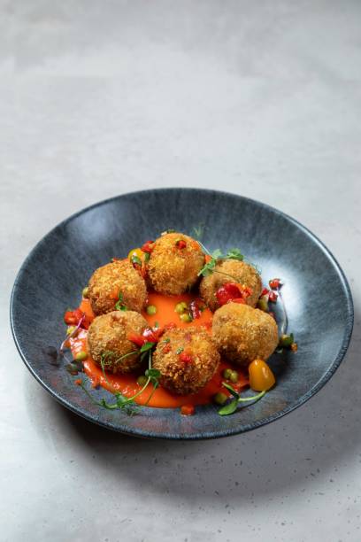 istock Arancini rice balls being served on grey plate with spicy tomato sauce 2177124950