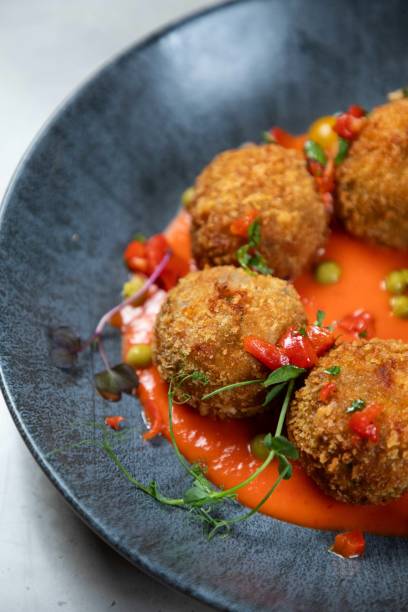 istock Delicious deep fried arancini rice balls served on grey plate with red sauce and garnish 2177124968