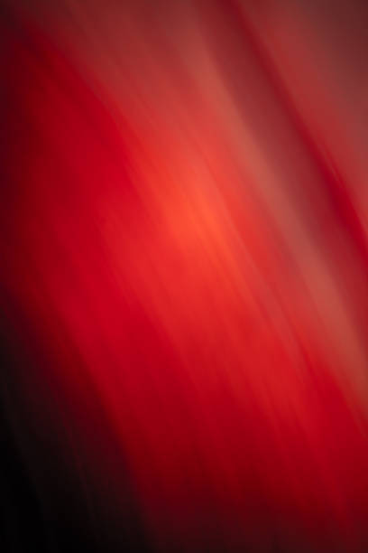 Abstract image with smooth red and orange gradients creating a fiery, flowing effect across the canvas. It combines warm tones that exude energy and movement through soft transitions.
