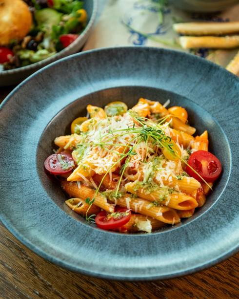 istock Penne pasta dish being served in restaurant setting 2177125341