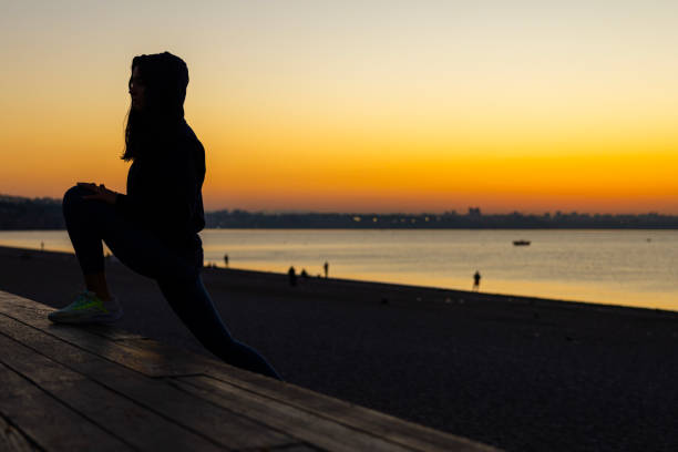 a woman exercising at the beach