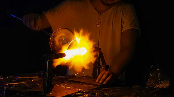 istock Artisan Hands in Handmade Glass Making Process with Glass Blowing Burner, 2177126084