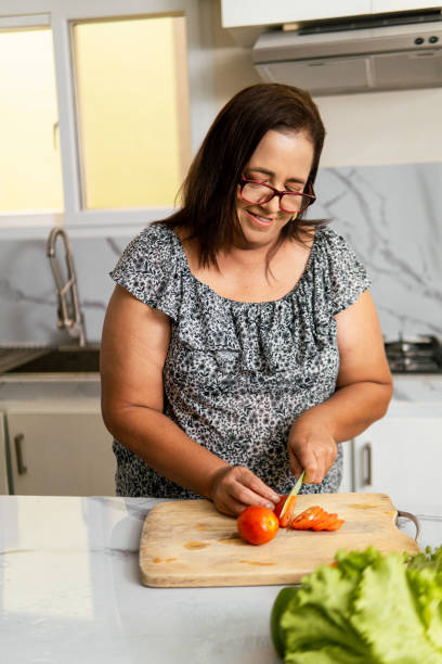 istock Hispanic Woman Preparing Food in Modern Kitchen 2177127989