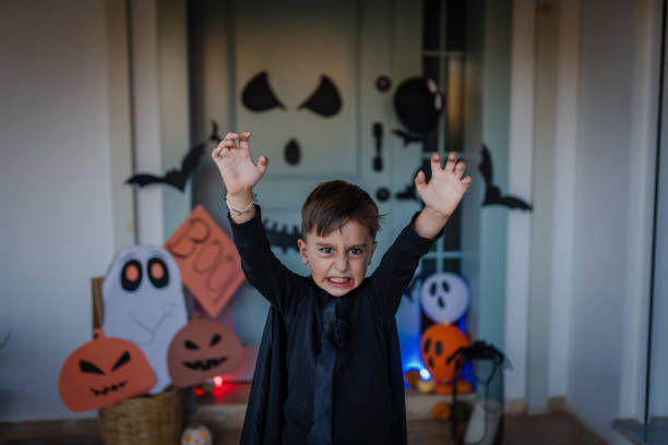Small boy trick or treating at night during Halloween