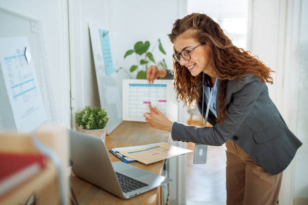 istock Young beautiful woman having video call while using laptop at modern office 2177130967