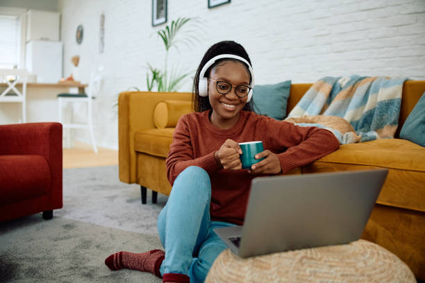 istock Happy black woman having video call over laptop while drinking tea at home. 2177132914