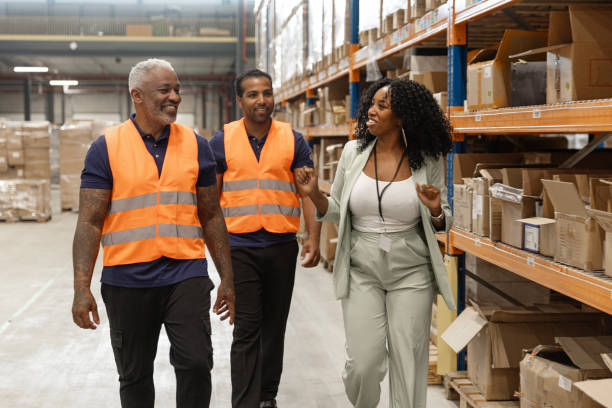 istock A beautiful black female warehouse manager with workers during the daily duties on site 2177132938