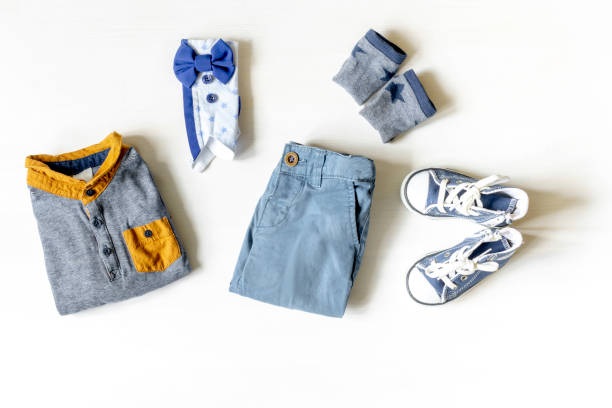 istock Different child clothes, shoes, sneakers, pants, accessories on white table with copy space, flat lay. Baby shower, decorations, stuff, present for boy birthday, newborn party 2177133147