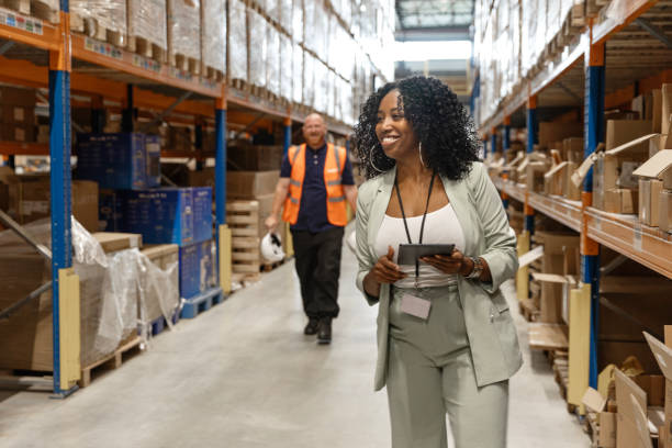 istock A beautiful black female warehouse manager with workers during the daily duties on site 2177133333