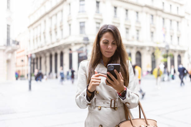 istock City Woman Using Smartphone on Street 2177133670