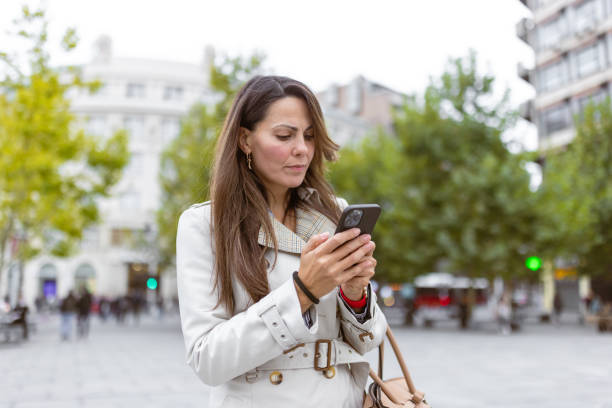 istock Woman Using Smartphone in Urban Park 2177133691