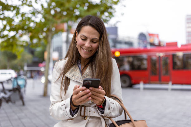 istock Woman Enjoying Smartphone in Urban Setting 2177133709