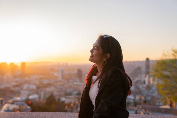 istock A asian woman is smiling and pointing at the sky 2177135105