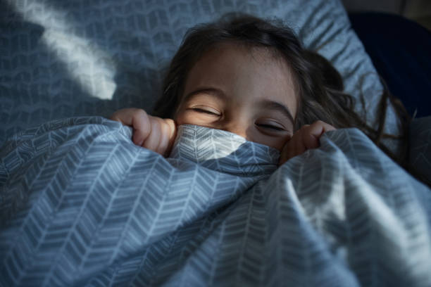 istock Adorable little girl playing during bedtime 2177135355