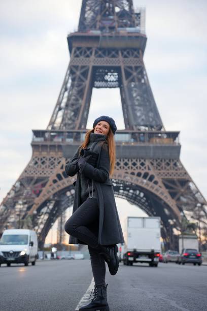 istock Parisian Style Woman in Grey Coat and Beret on Highway with Eiffel Tower 2177136776