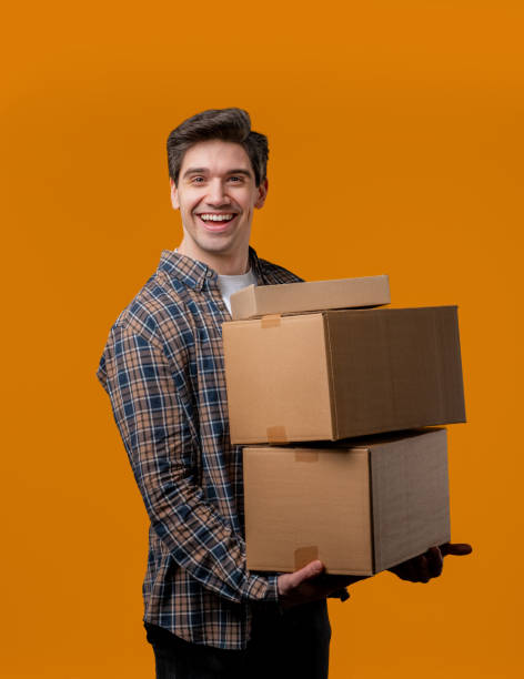 istock Excited smiling man, online shopping consumer received cardboard order parcels boxes, desired purchase. Home courier delivery service. Sale, discounts 2177138186