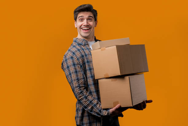 istock Excited smiling man, online shopping consumer received cardboard order parcels boxes, desired purchase. Home courier delivery service. Sale, discounts 2177138189