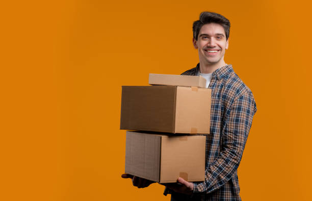 istock Excited smiling man, online shopping consumer received cardboard order parcels boxes, desired purchase. Home courier delivery service. Sale, discounts 2177138201