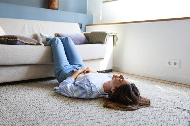 istock Young woman relaxing on carpet at home 2177138335