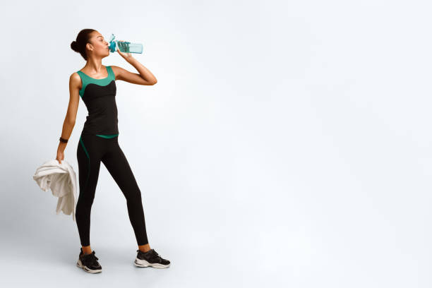 istock Sporty African American Lady Drinking Water During Workout In Studio 2177140073