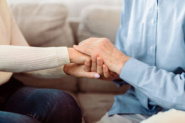 istock Happy elderly couple holding hands at home 2177141183