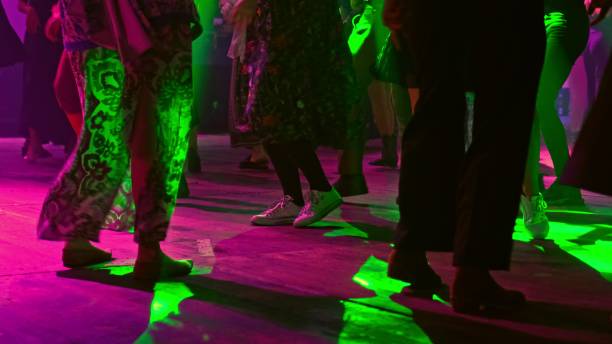 istock Anonymous Crowd of People Having Fun Dancing on Disco Dance Floor with Colorful Party Light Strobe Laser Projector Low Angle 2177143987