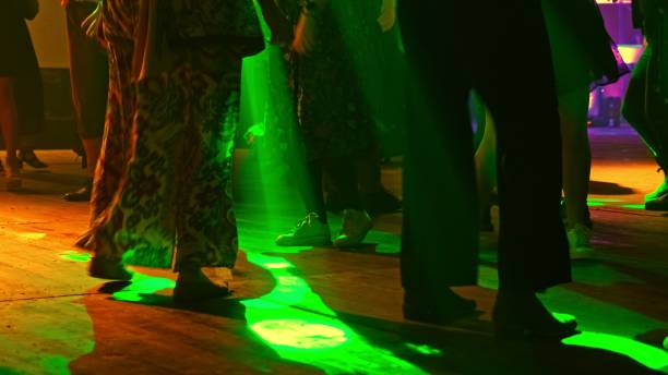 istock Anonymous Crowd of People Having Fun Dancing on Disco Dance Floor with Colorful Party Light Strobe Laser Projector Low Angle 2177143991