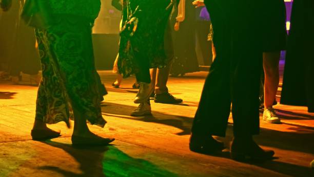 istock Anonymous Crowd of People Having Fun Dancing on Disco Dance Floor with Colorful Party Light Strobe Laser Projector Low Angle 2177143992
