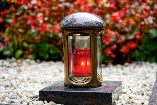 istock lantern in a cemetery with a burning red candle on a marble pedestal 2177150937