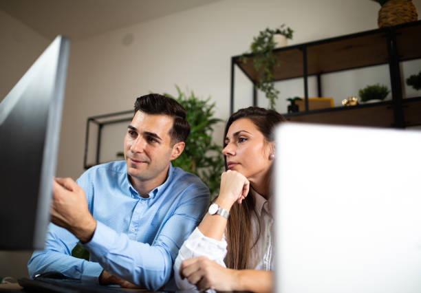 istock Two young colleagues working together at modern office stock photoOffice, Technology, Computer, Trainee, Working 2177152487