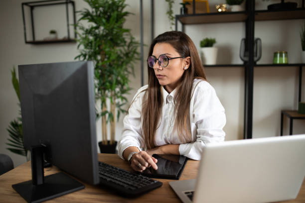 istock Woman working on laptop online, checking emails and planning on the internet while sitting in an office alone at work. Business woman, corporate professional or manager searching the internet stock photo
People, Using Computer, Computer, Laptop,One Person 2177152523