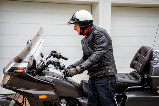 istock Man on Touring Motorcycle in Front of Garage 2177154287