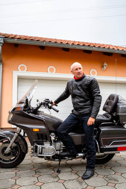 istock Man posing with Motorcycle in Front of Garage 2177154297