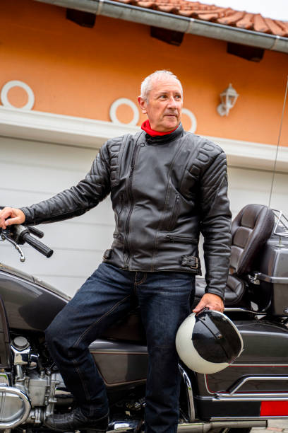 istock Man posing with Motorcycle in Front of Garage 2177154313