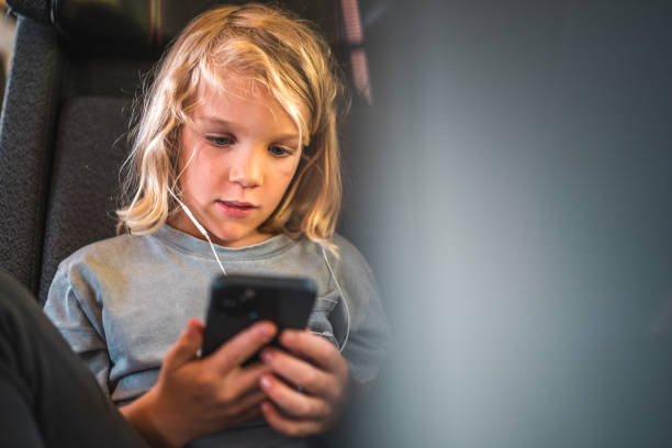 istock Caucasian Boy on a Train Using Smartphone and Earphones 2177158332