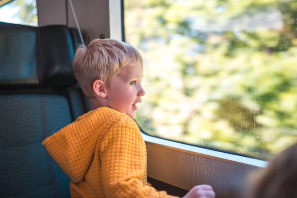 istock Caucasian Boy Curiously Looking Through the Window 2177158358