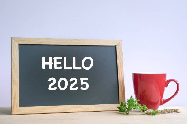 istock Hello 2025, text on a blackboard next to coffee in red cup. 2177160904