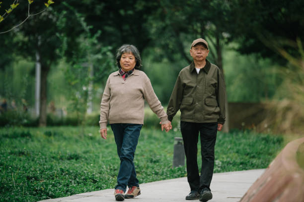 istock Senior couple walking together in park 2177166018