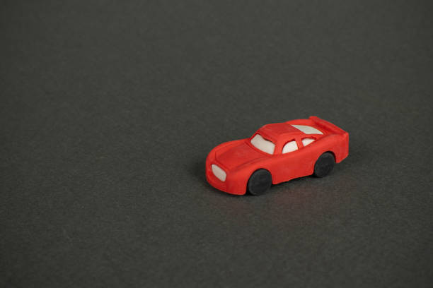 Red Toy Car on Matte Black Surface - Minimalist Stock Photo for Design Projects