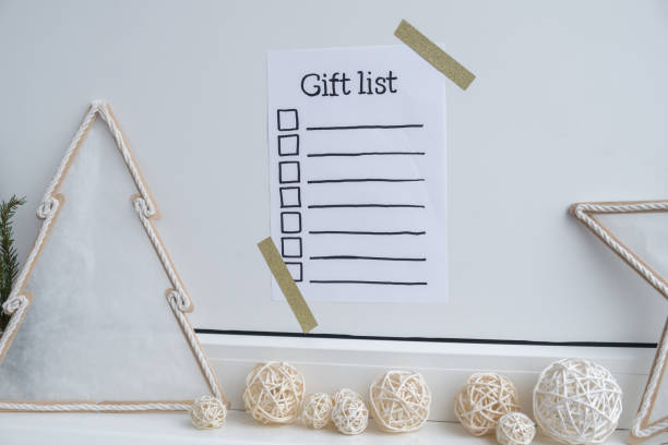 istock Preparation for winter holidays. GIFT LIST text on paper note. Celebration gifts and presents preparing Natural zero waste homemade Christmas decor. Happy new year 2177176711