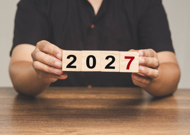 istock Hands showing 2027 on wooden blocks, representing future, countdown, and new beginnings. 2177178361