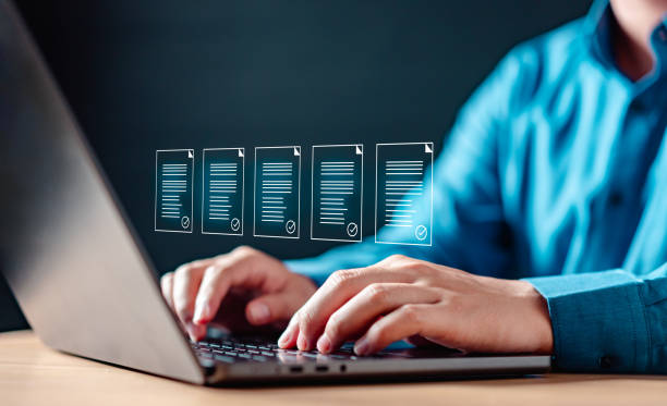 istock A man is typing on a laptop, The laptop screen shows a series of documents. 2177180618