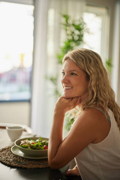 istock Happy woman day dreaming during breakfast at home. 2177183313