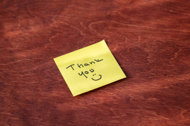 istock Yellow Sticky Note with Handwritten “Thank You” and Smiley Face – Expressing Gratitude and Appreciation in a Fun, Personal Way, Perfect for Office or Business Themes 2177183986