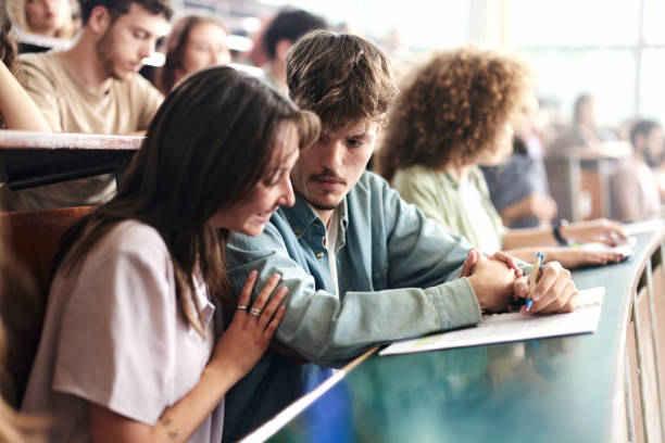 istock Young college couple having a class at lecture hall. 2177185658