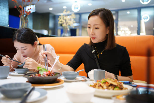 istock Asian woman eating in restaurant 2177187096