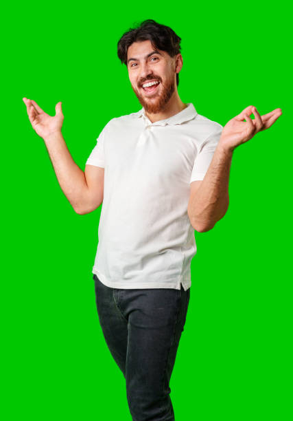 istock Young man expresses surprise in front of a bright green background 2177187556