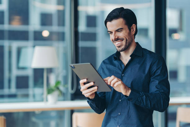 istock Smiling businessman holding a digital tablet 2177187702