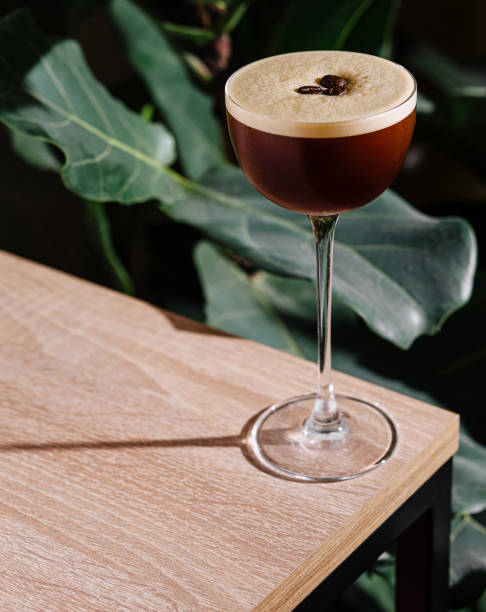 istock Espresso martini cocktail standing on wooden table in tropical atmosphere 2177187735