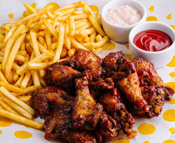 istock Crispy chicken wings and fries with dips on table 2177188296